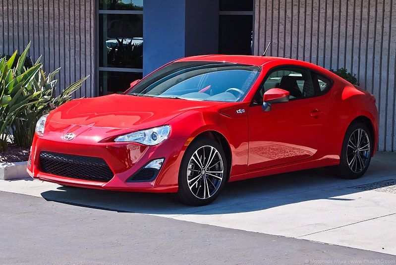 Red Scion parked in driveway