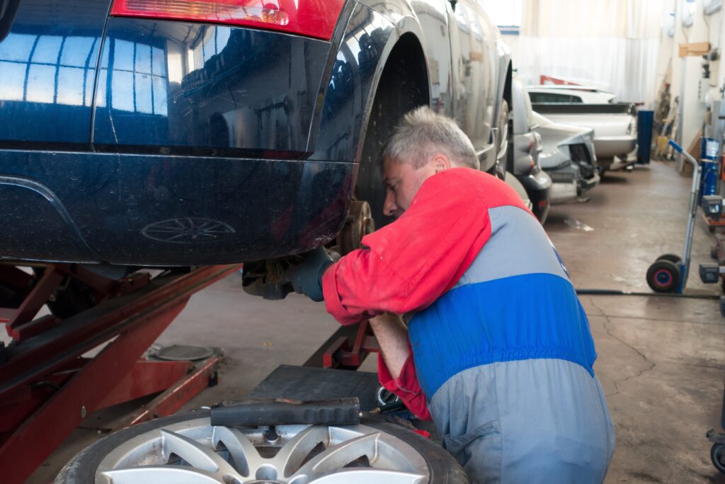 Mechanic expertly repairing car's steering and suspension system